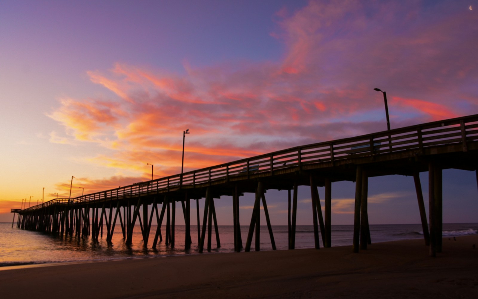 silhouette of bridge under orange sky